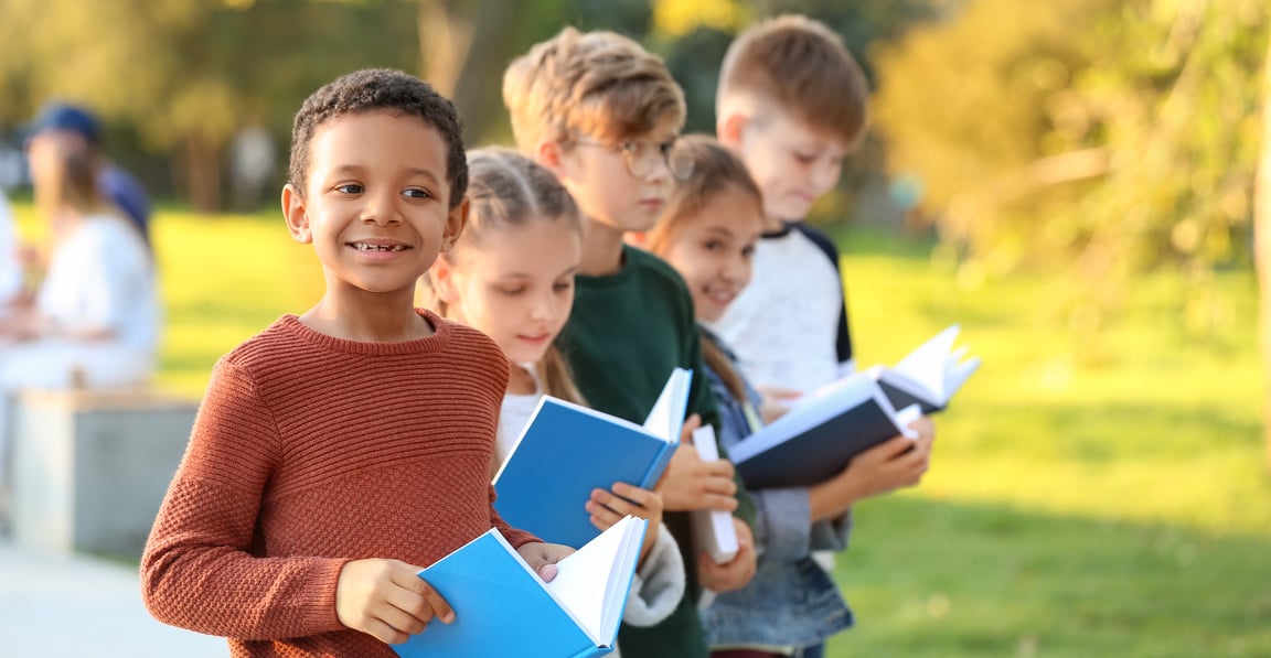 Cute Little Children Reading Books in Park