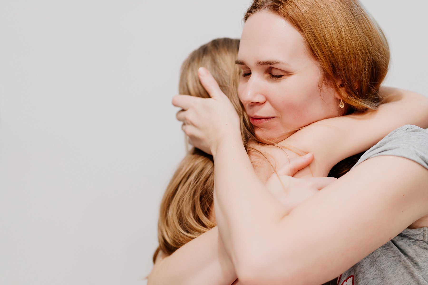 Mom hugs and comforts her little daughter. children's fears and tantrums.